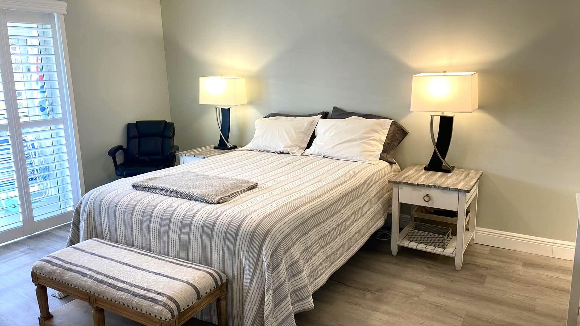1856 Southwest Palm City Road, Unit 203 Stuart, FL 34994 - Photo 12 of 22 a bedroom with a bed and a mirror