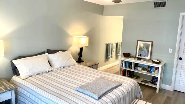 a bedroom with a bed and a night stand