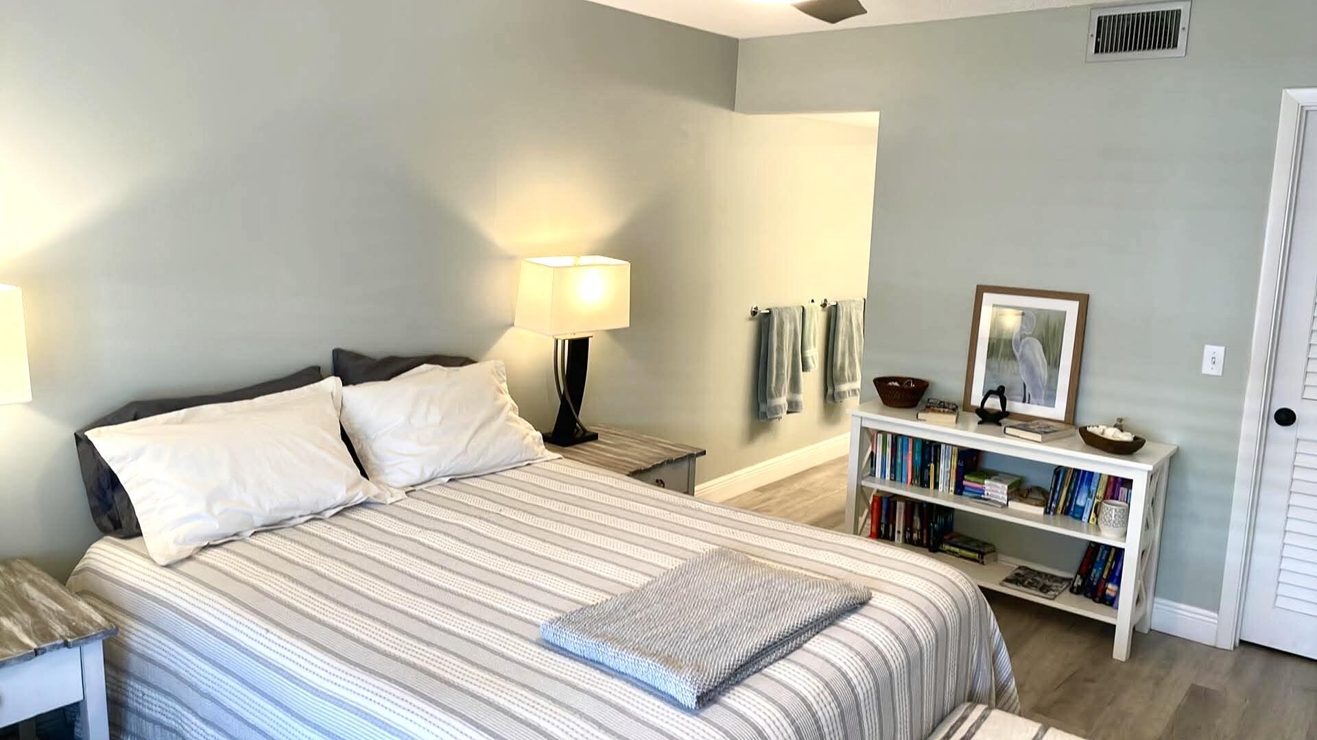 1856 Southwest Palm City Road, Unit 203 Stuart, FL 34994 - Photo 13 of 22 a bedroom with a bed and a night stand