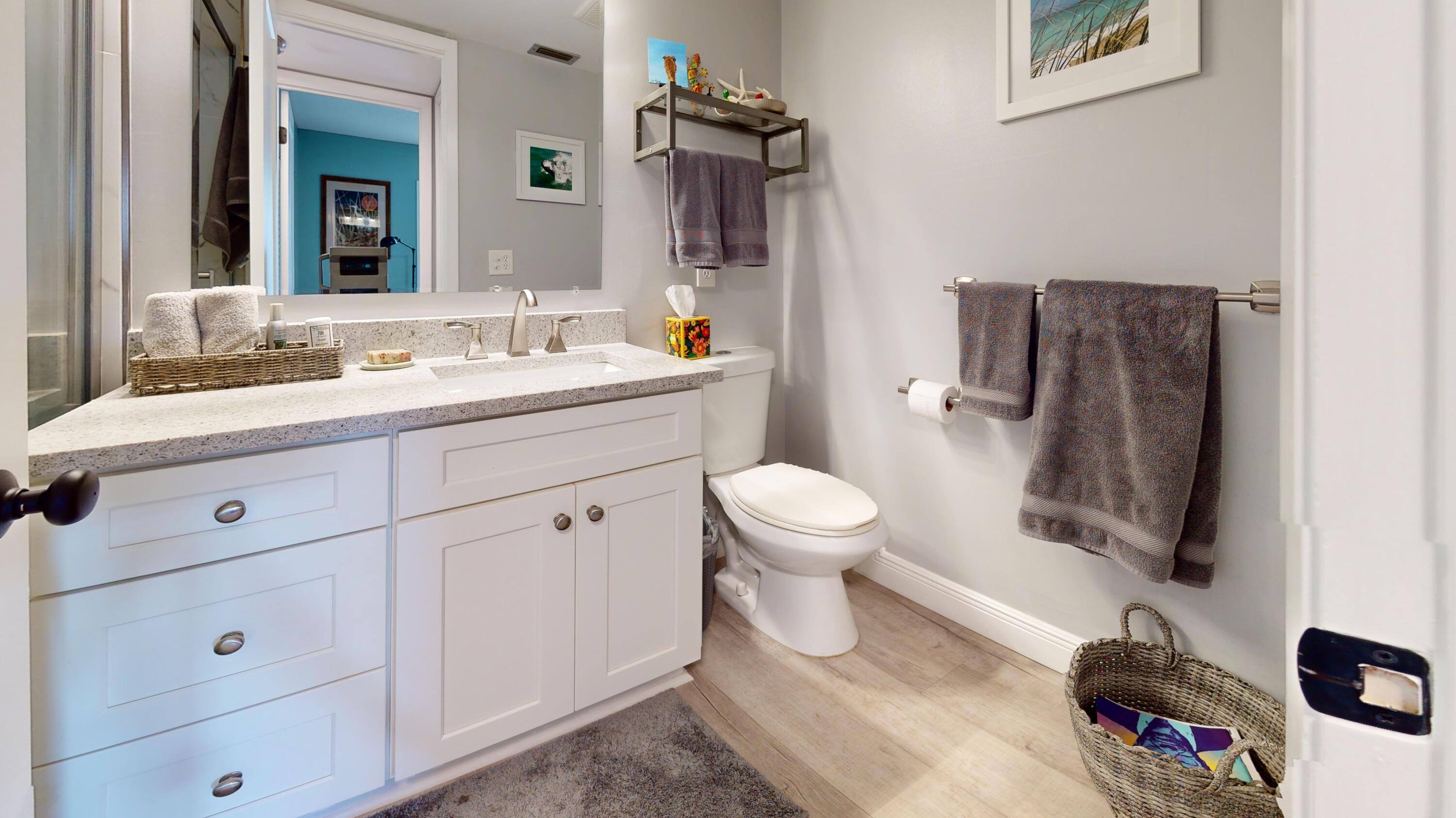 1856 Southwest Palm City Road, Unit 203 Stuart, FL 34994 - Photo 19 of 22 a bathroom with a toilet sink and mirror