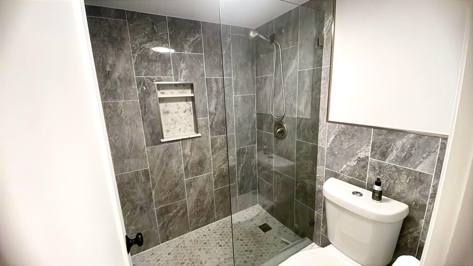 1856 Southwest Palm City Road, Unit 203 Stuart, FL 34994 - Photo 21 of 22 a bathroom with a toilet and a shower