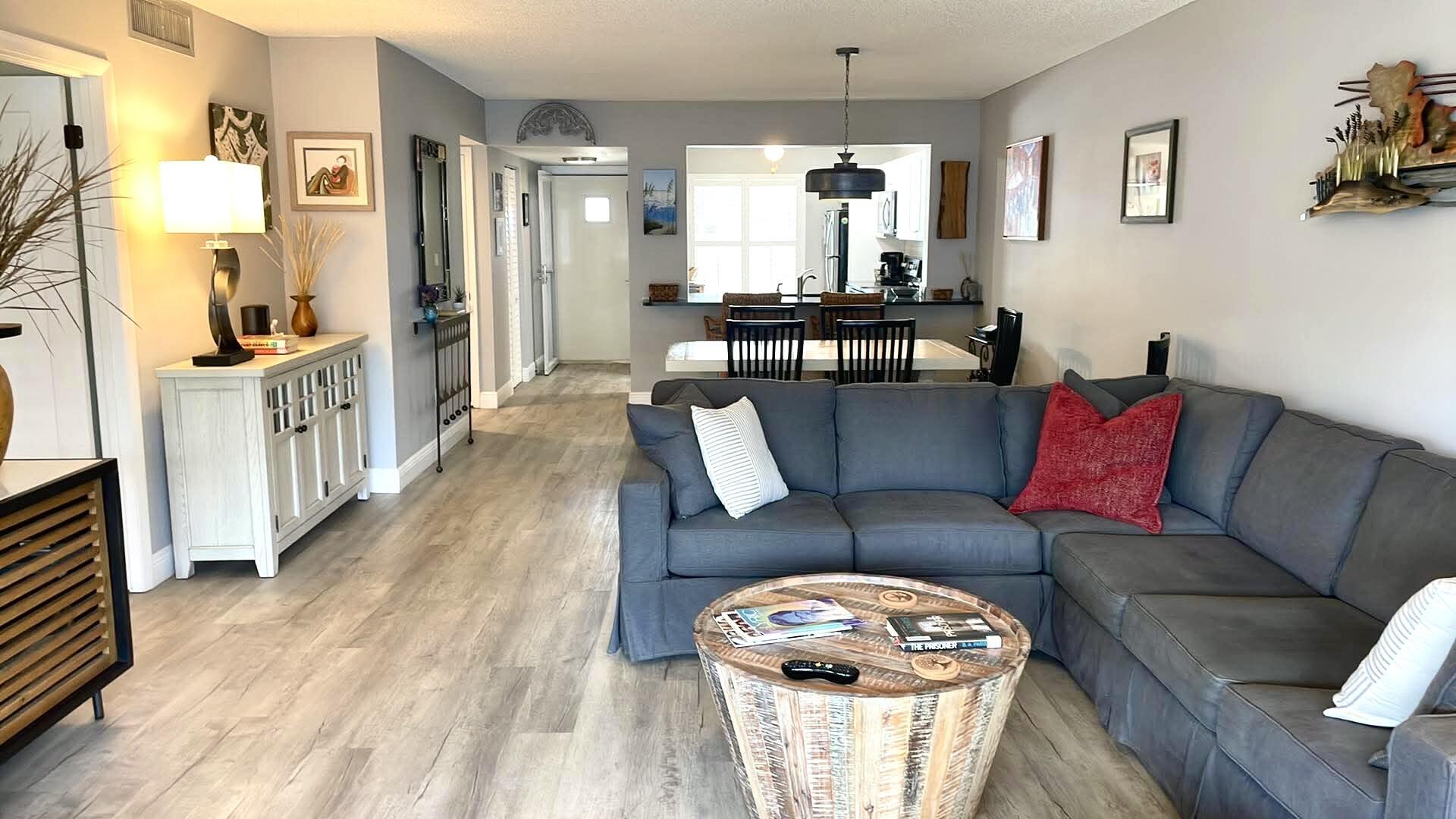 1856 Southwest Palm City Road, Unit 203 Stuart, FL 34994 - Photo 3 of 22 a living room with furniture and a wooden floor