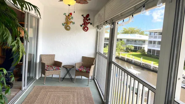 a view of a chairs and table in a balcony