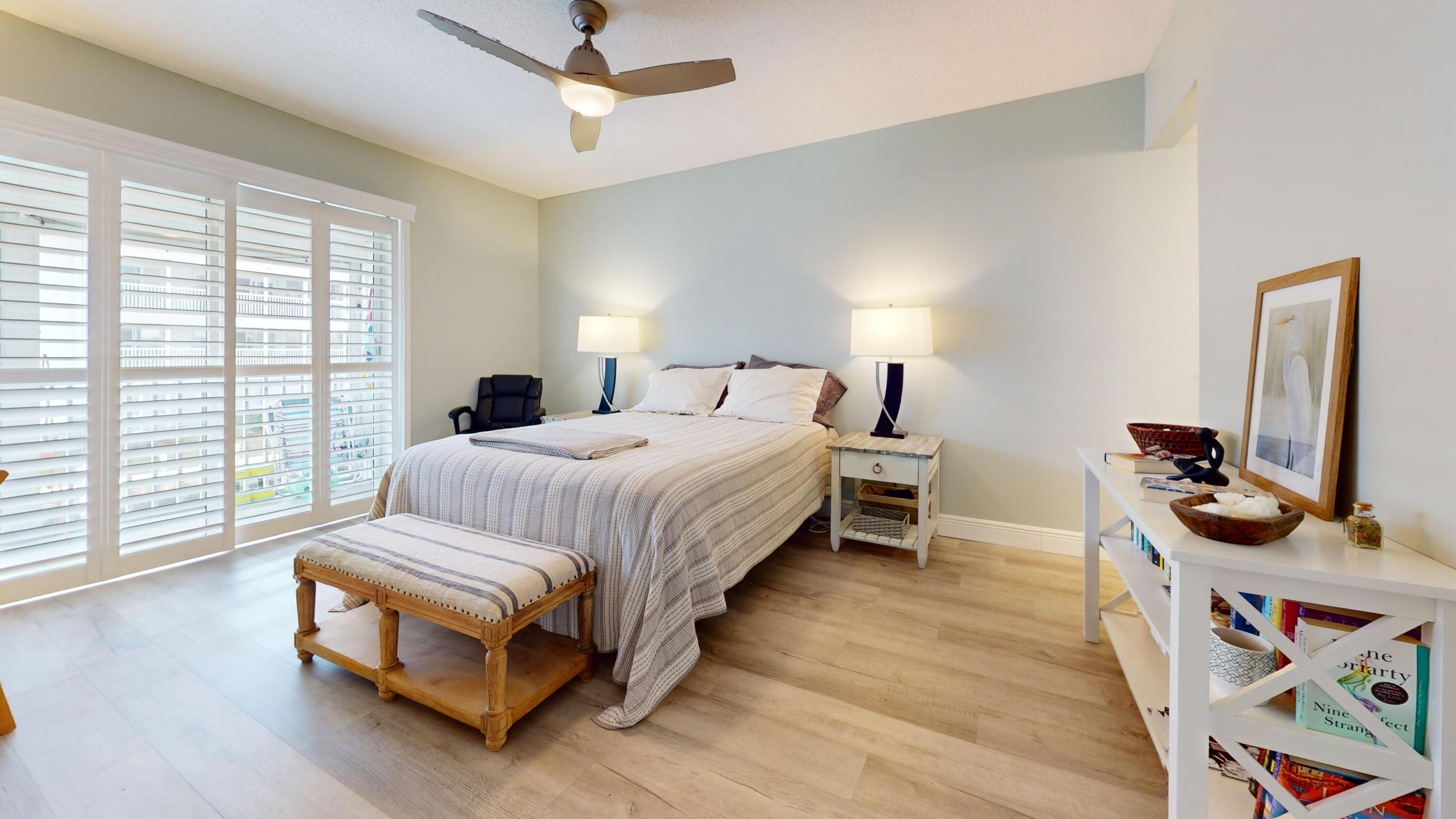 1856 Southwest Palm City Road, Unit 203 Stuart, FL 34994 - Photo 10 of 22 a bedroom with a bed next to a window