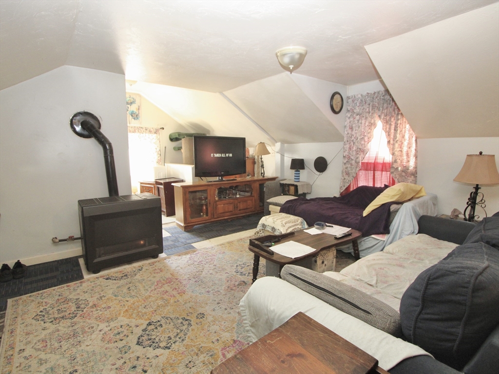 5 Benham Street Worcester, MA 01604 - Photo 14 of 18 a bedroom with furniture and a flat screen tv