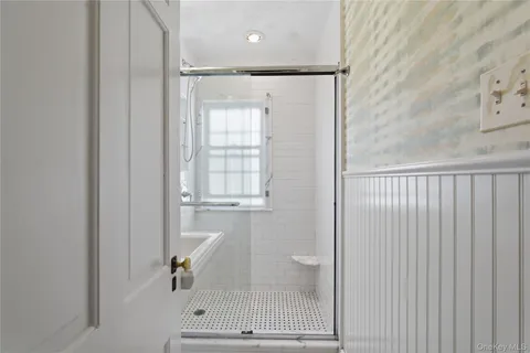 a bathroom with a glass shower door