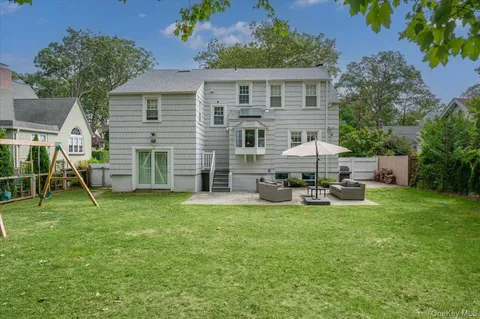 a view of a house with backyard sitting area and garden