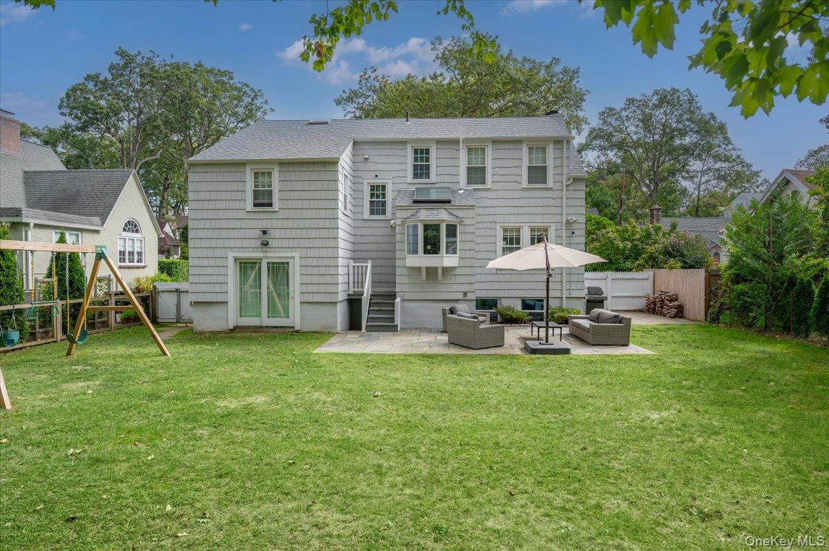 32 Kingsbury Road New Rochelle, NY 10804 - Photo 25 of 31 a view of a house with backyard sitting area and garden