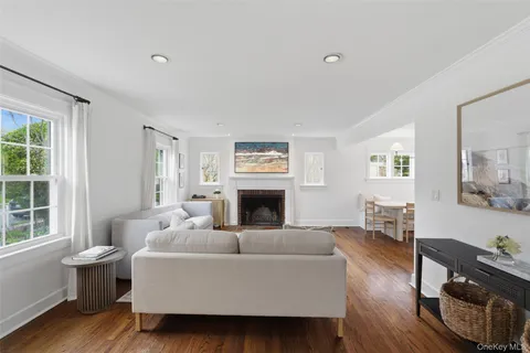 a living room with furniture a fireplace and a window