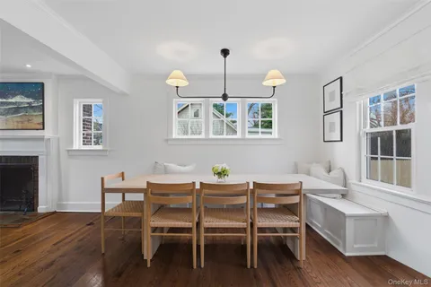 a dining room with furniture a chandelier and wooden floor