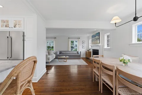 a view of a dining room with furniture a rug and wooden floor