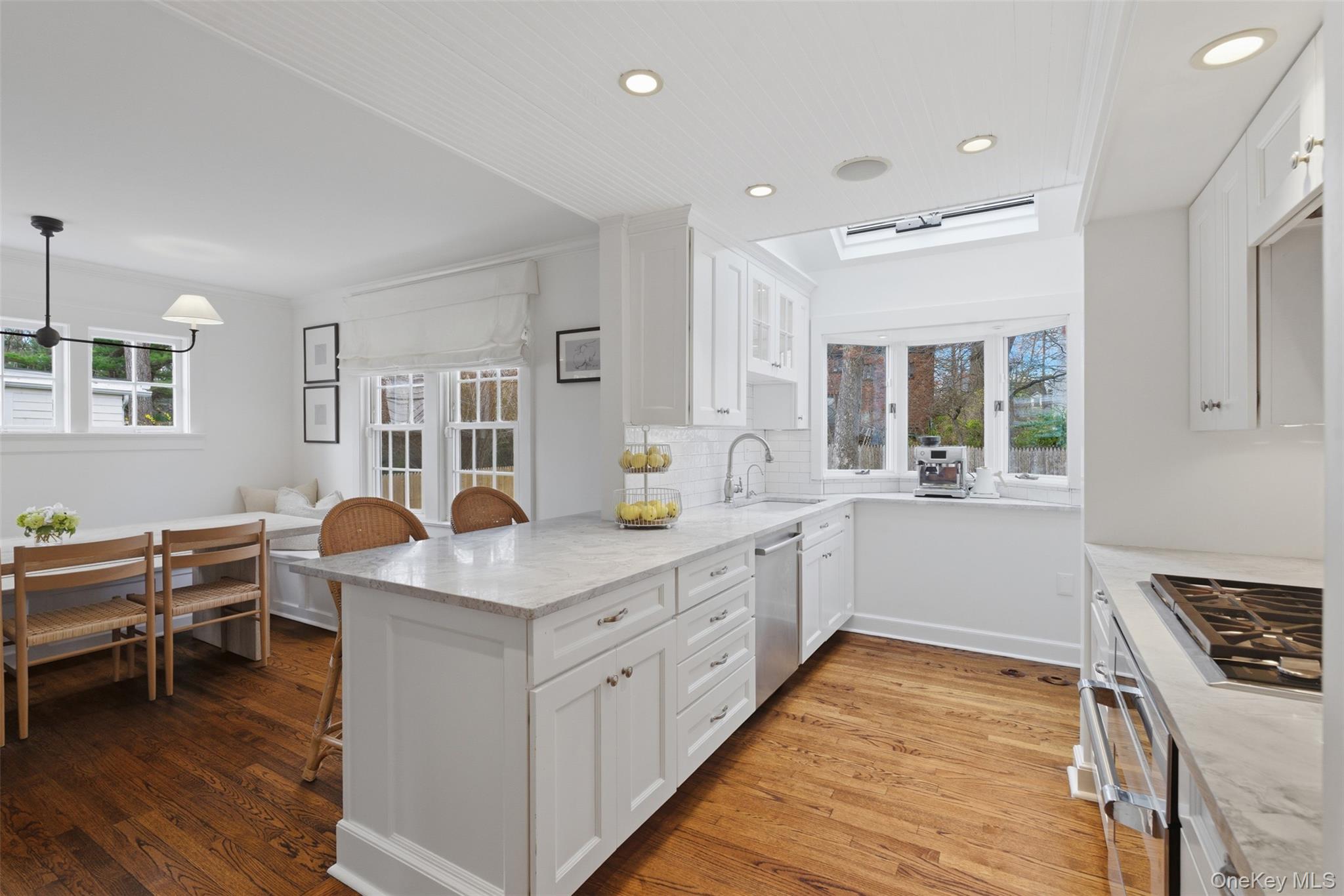 32 Kingsbury Road New Rochelle, NY 10804 - Photo 10 of 31 a kitchen that has a lot of white cabinets and wooden floor