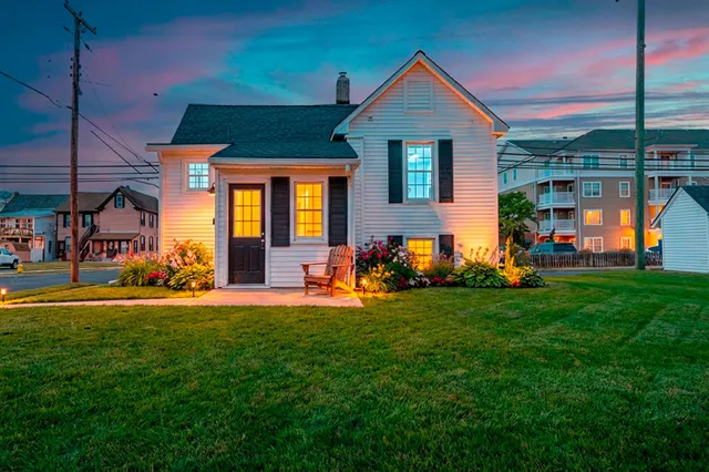 a front view of a house with a yard table and chairs