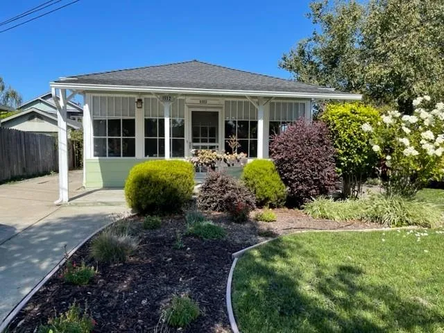 a front view of a house with garden and porch