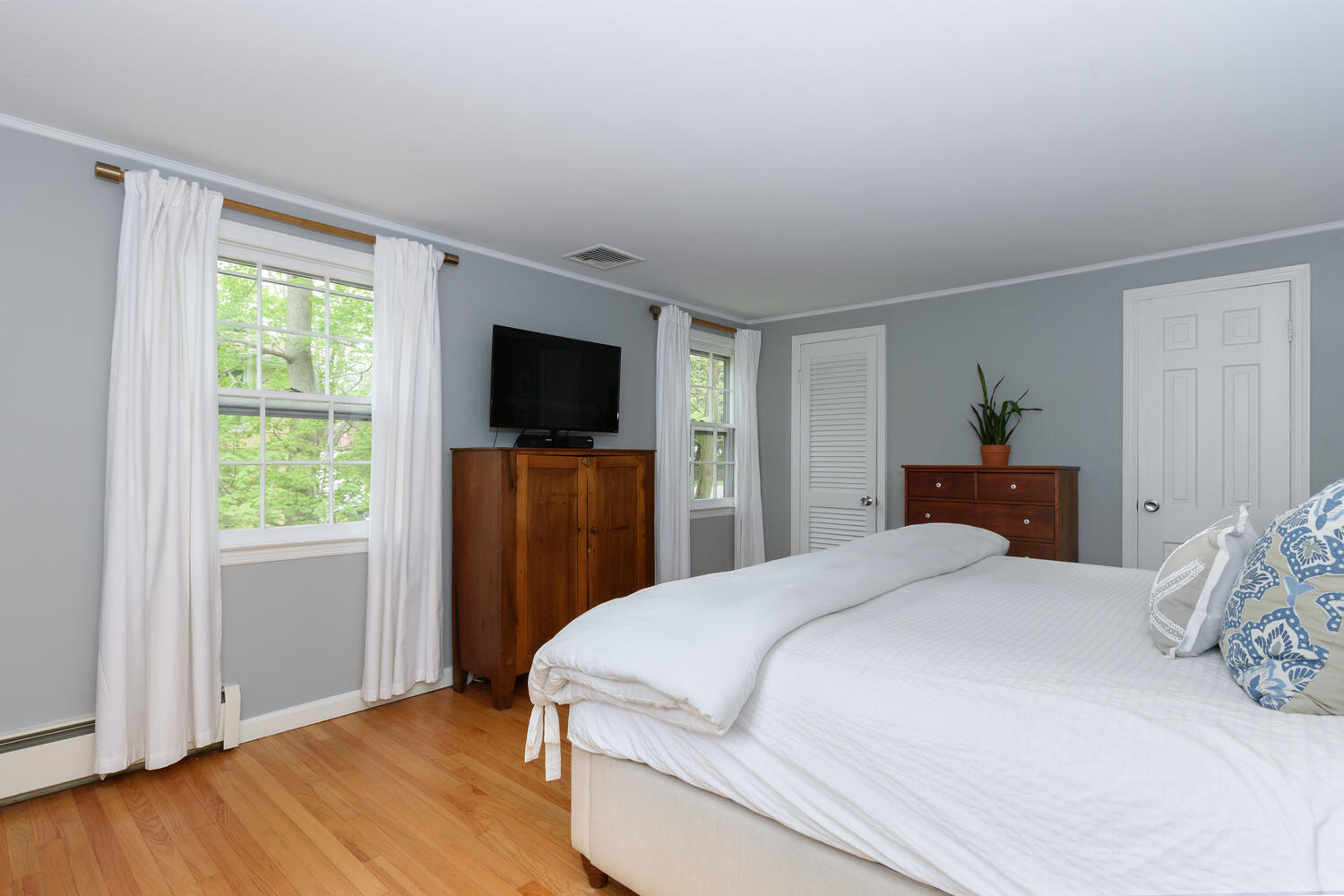 27 Hollow Tree Ridge Road Darien, CT 06820 - Photo 14 of 27 a bedroom with a bed and a flat screen tv