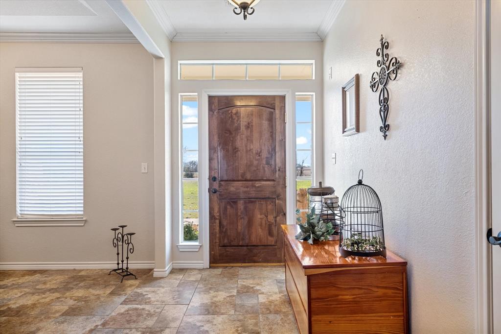 2885 Enloe Road Howe, TX 75459 - Photo 15 of 39 a room that has painting on the wall and a potted plant