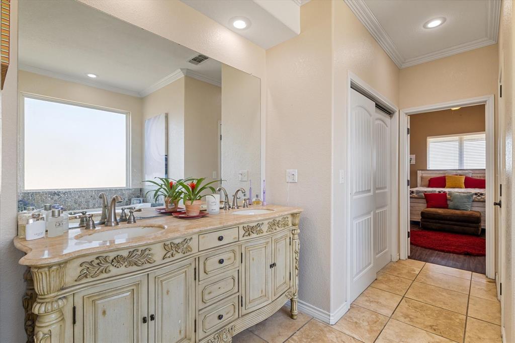 2885 Enloe Road Howe, TX 75459 - Photo 26 of 39 a bathroom with a sink and a mirror