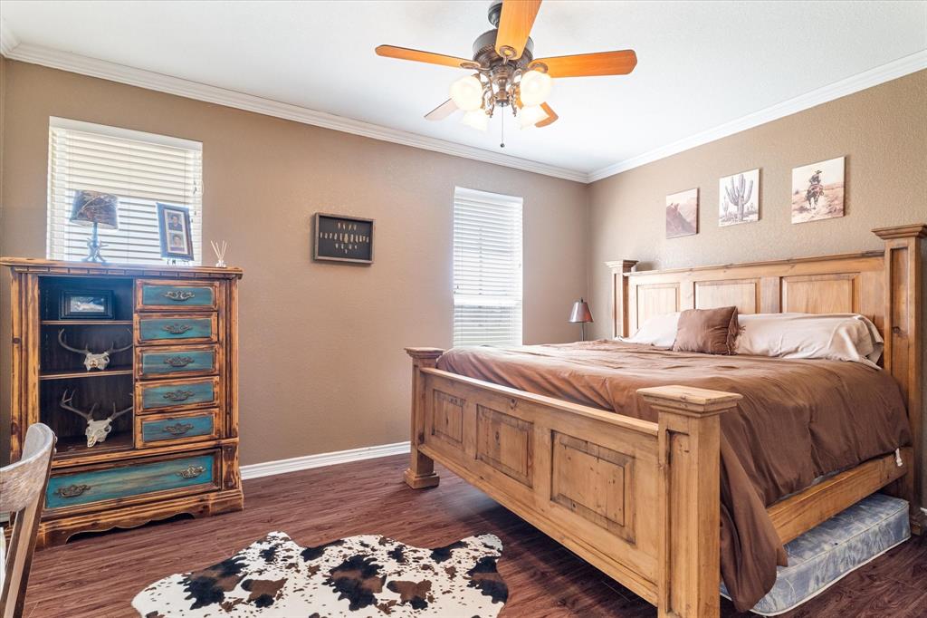 2885 Enloe Road Howe, TX 75459 - Photo 27 of 39 a bedroom with a bed and a chandelier