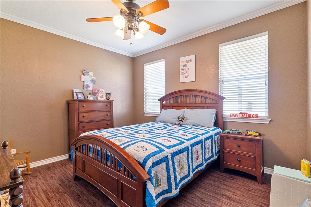 2885 Enloe Road Howe, TX 75459 - Photo 29 of 39 a bedroom with a bed and a chandelier