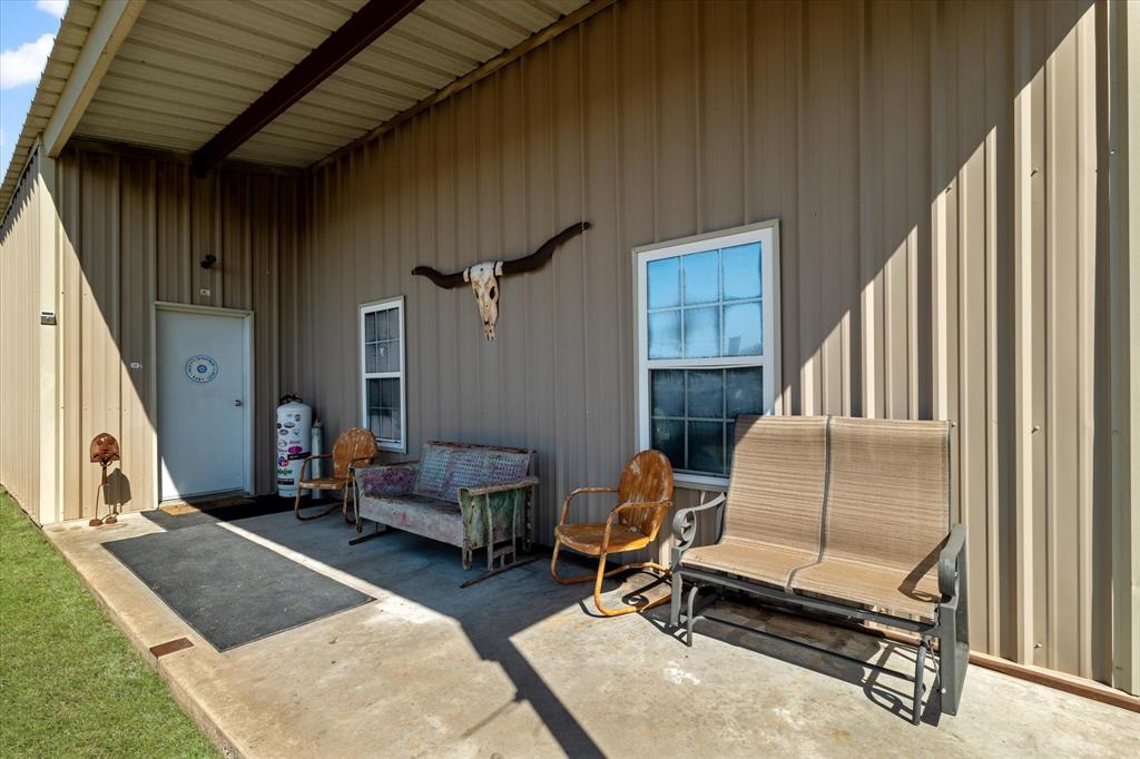 2885 Enloe Road Howe, TX 75459 - Photo 35 of 39 a living room with furniture gym equipment and a fireplace