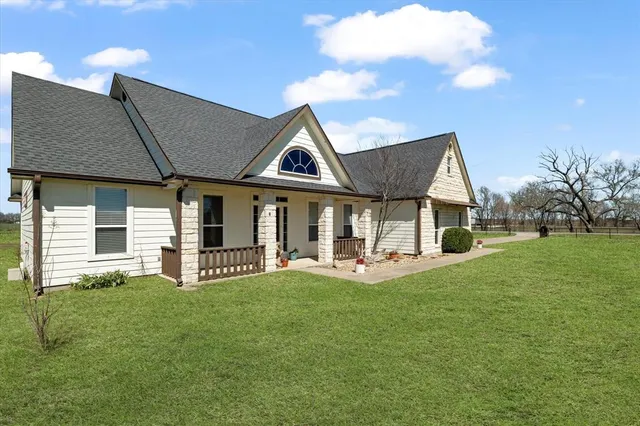 a view of backyard with barbeque grill and a small yard