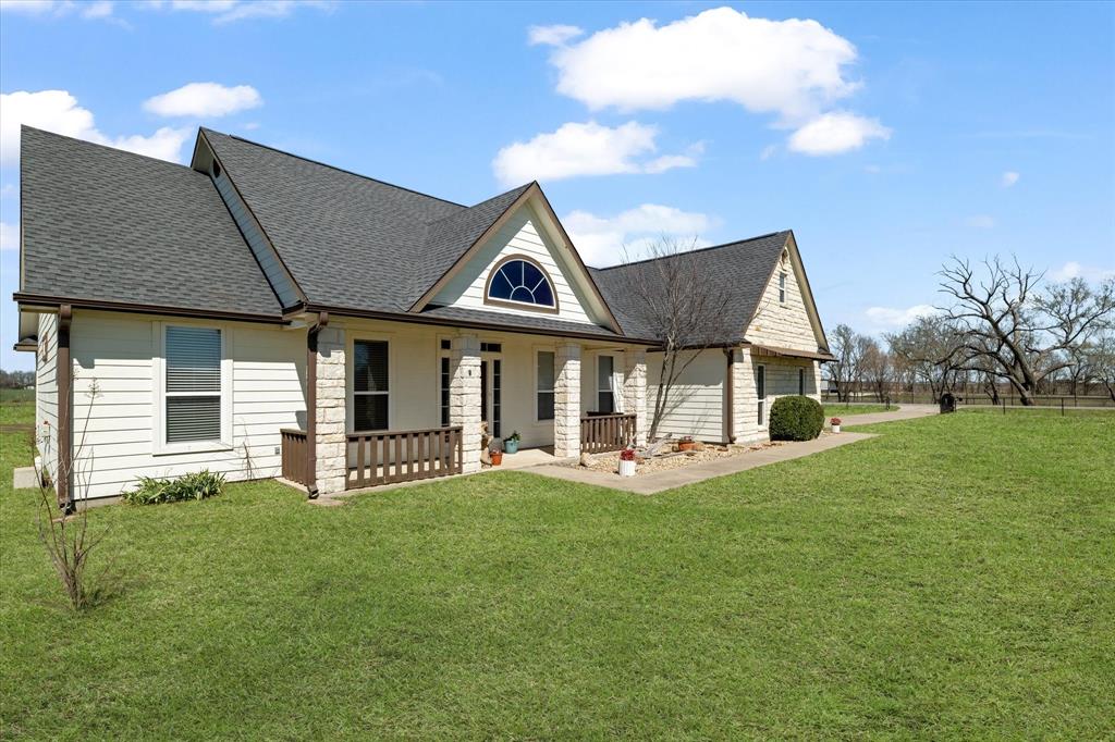 2885 Enloe Road Howe, TX 75459 - Photo 10 of 39 a front view of a house with a yard table and chairs