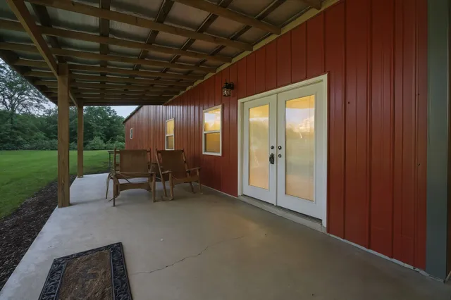 a view of a room with chairs and a patio