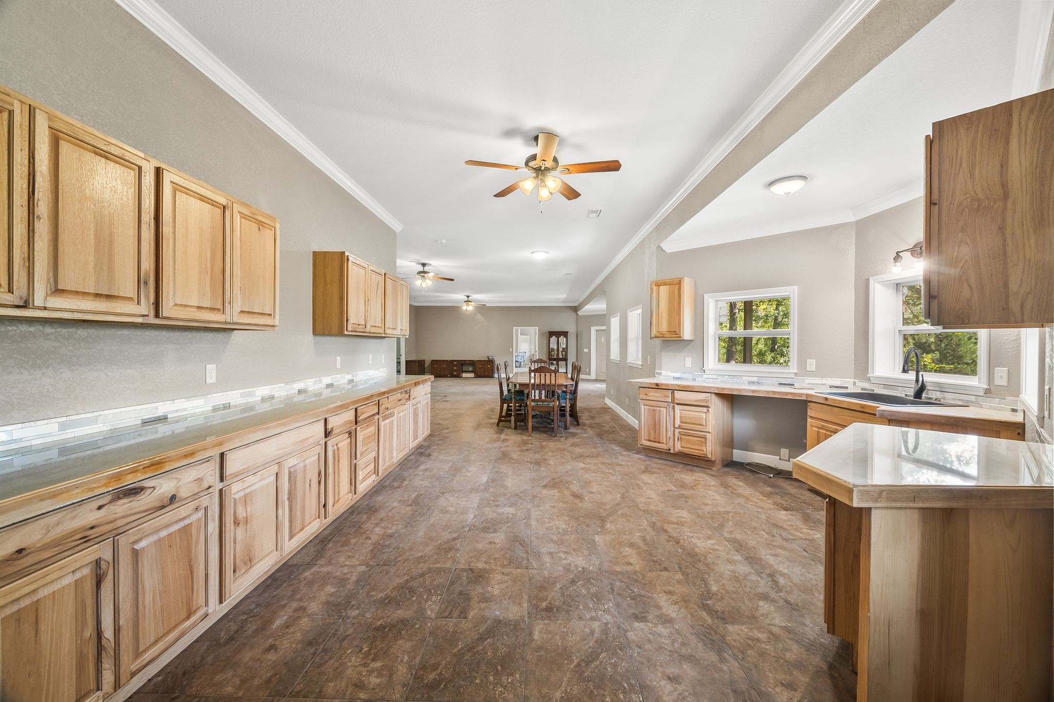 1582 Hellsneck Road Waverly, TN 37185 - Photo 27 of 72 a large kitchen with kitchen island a large counter space a sink a window and stainless steel appliances