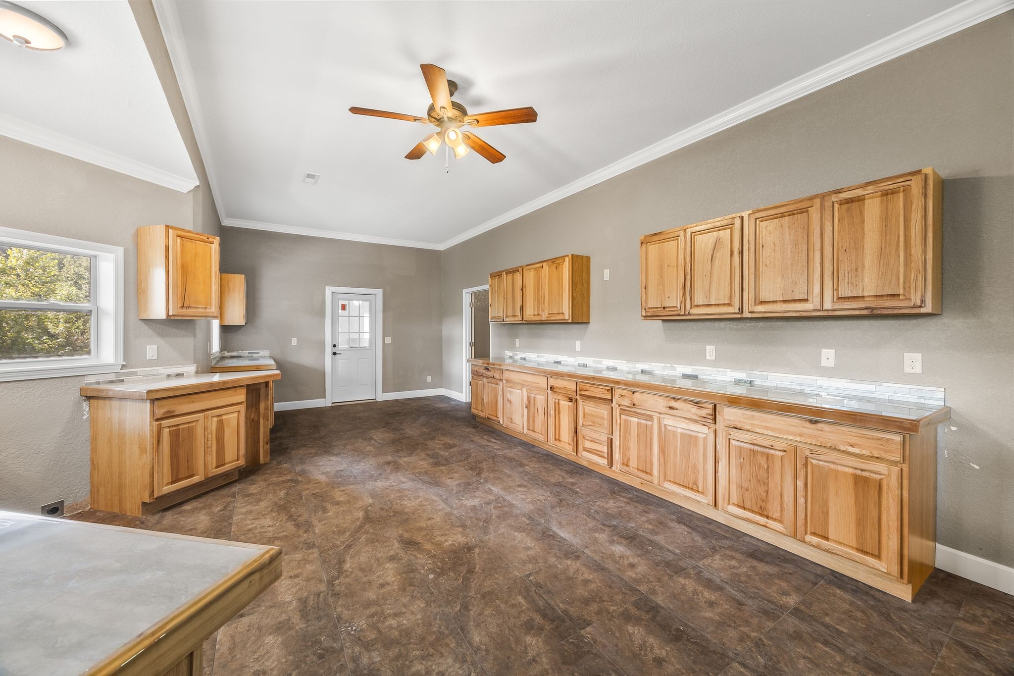 1582 Hellsneck Road Waverly, TN 37185 - Photo 29 of 72 a large kitchen with stainless steel appliances granite countertop a sink a stove cabinets counter space and a window