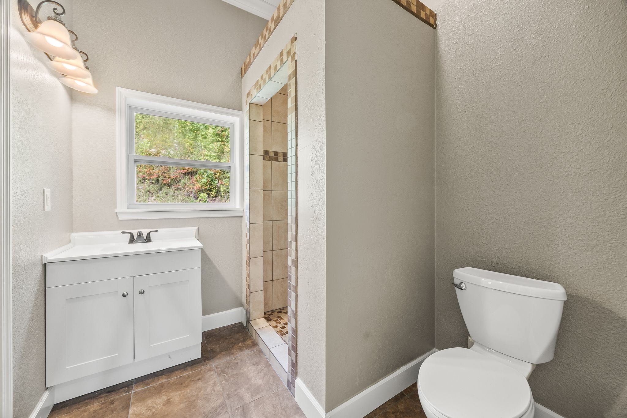 1582 Hellsneck Road Waverly, TN 37185 - Photo 49 of 72 a bathroom with a toilet sink and window