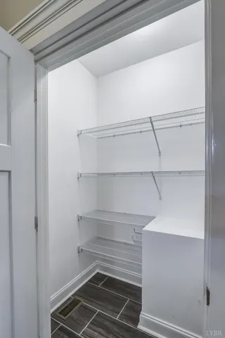 a view of storage and utility room with racks on the wall