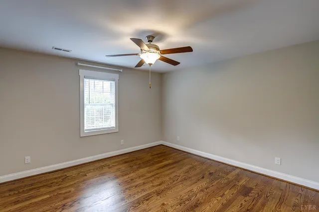 an aerial view of residential house with outdoor space and trees all around