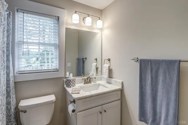 front view of a house with a yard and an window