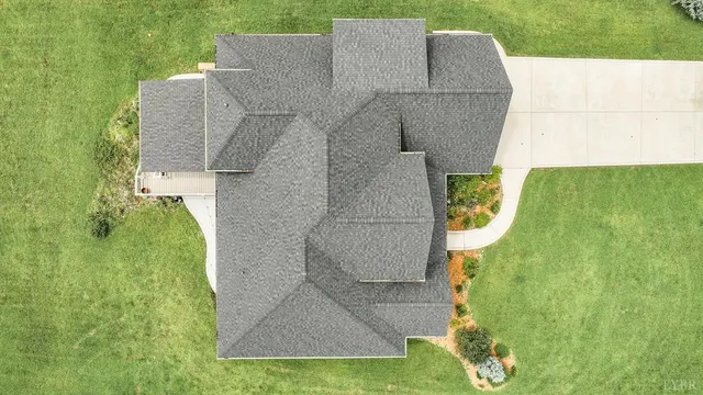 an aerial view of a house with a yard basket ball court