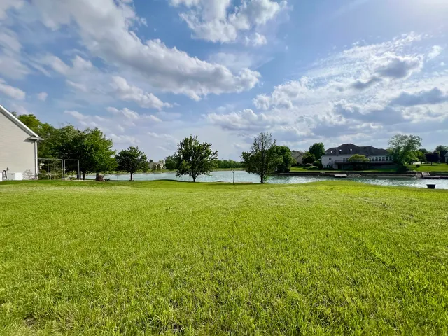 a view of a swimming pool and a yard