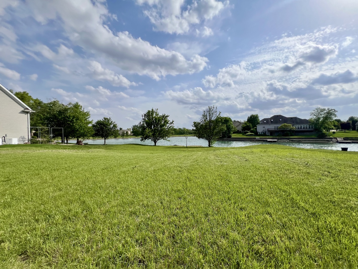 4309 Stonebridge Court Champaign, IL 61822 - Photo 2 of 8 a view of a golf course with a garden