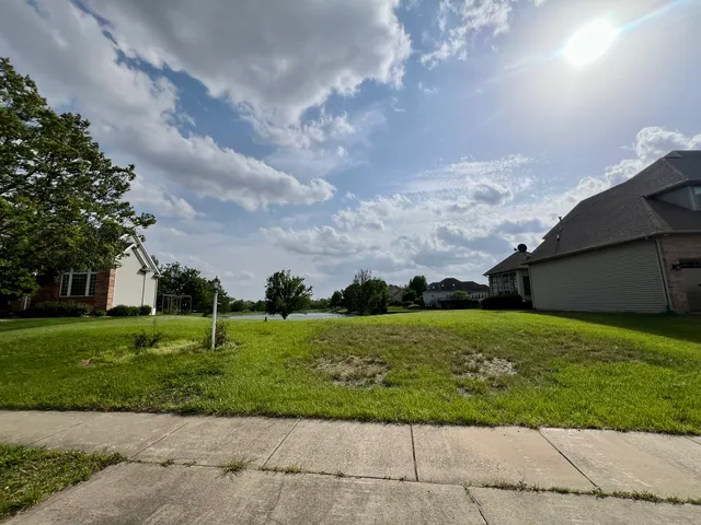 a view of a garden with a building in the background