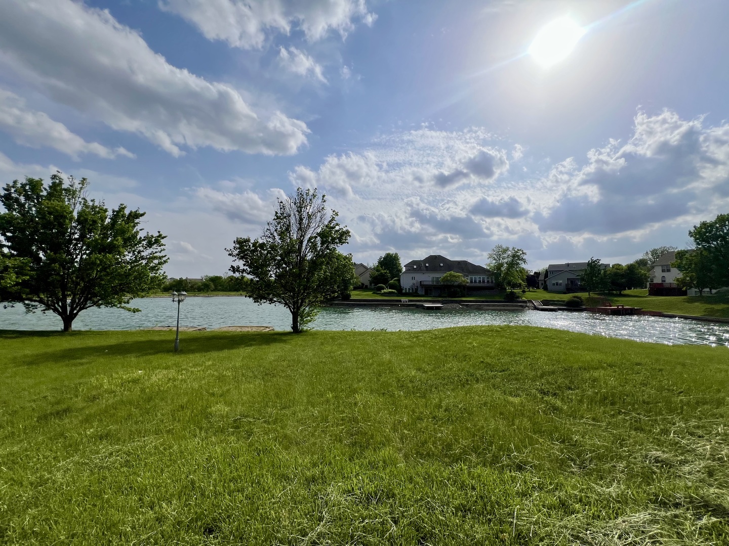 4309 Stonebridge Court Champaign, IL 61822 - Photo 7 of 8 a view of a golf course with a lake