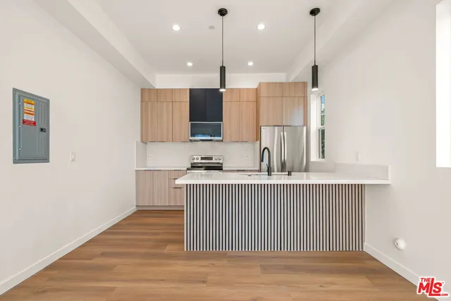 a living room with furniture floor to ceiling window and wooden floor