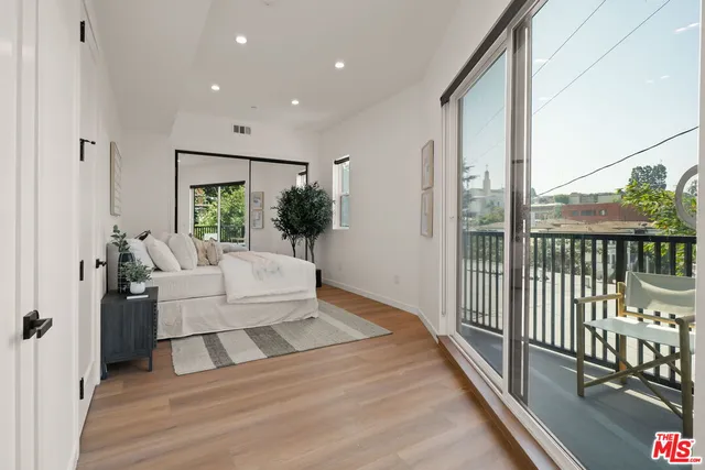 a spacious bedroom with a large bed and a large window
