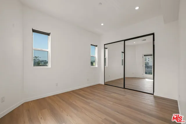 a bedroom with a bed and a potted plant