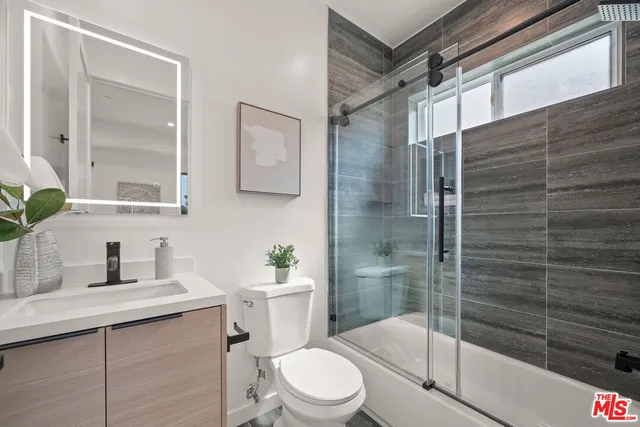 a bedroom with a bed and a night stand