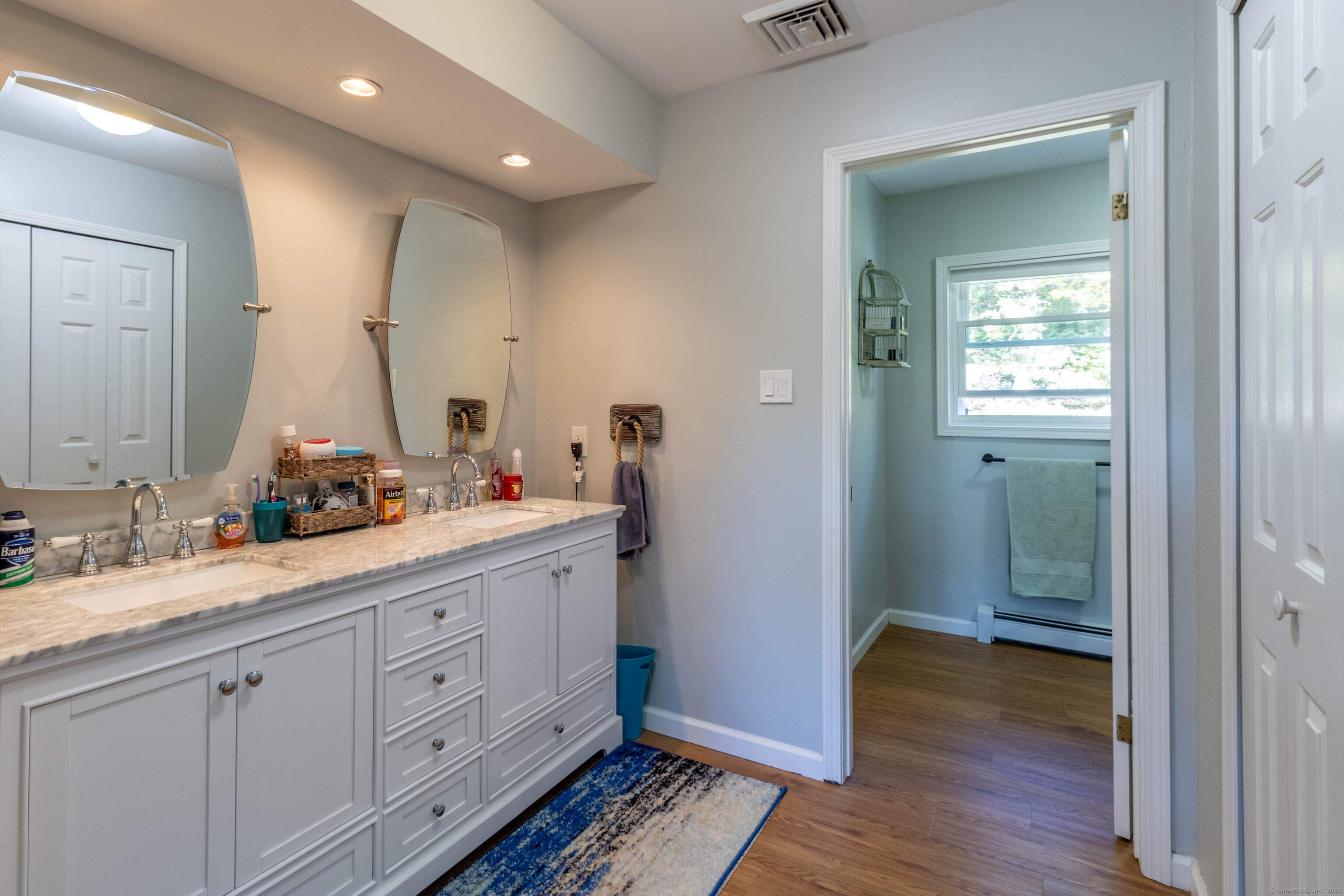 26 Firetown Road Simsbury, CT 06070 - Photo 11 of 40 a spacious bathroom with a double vanity sink and mirror