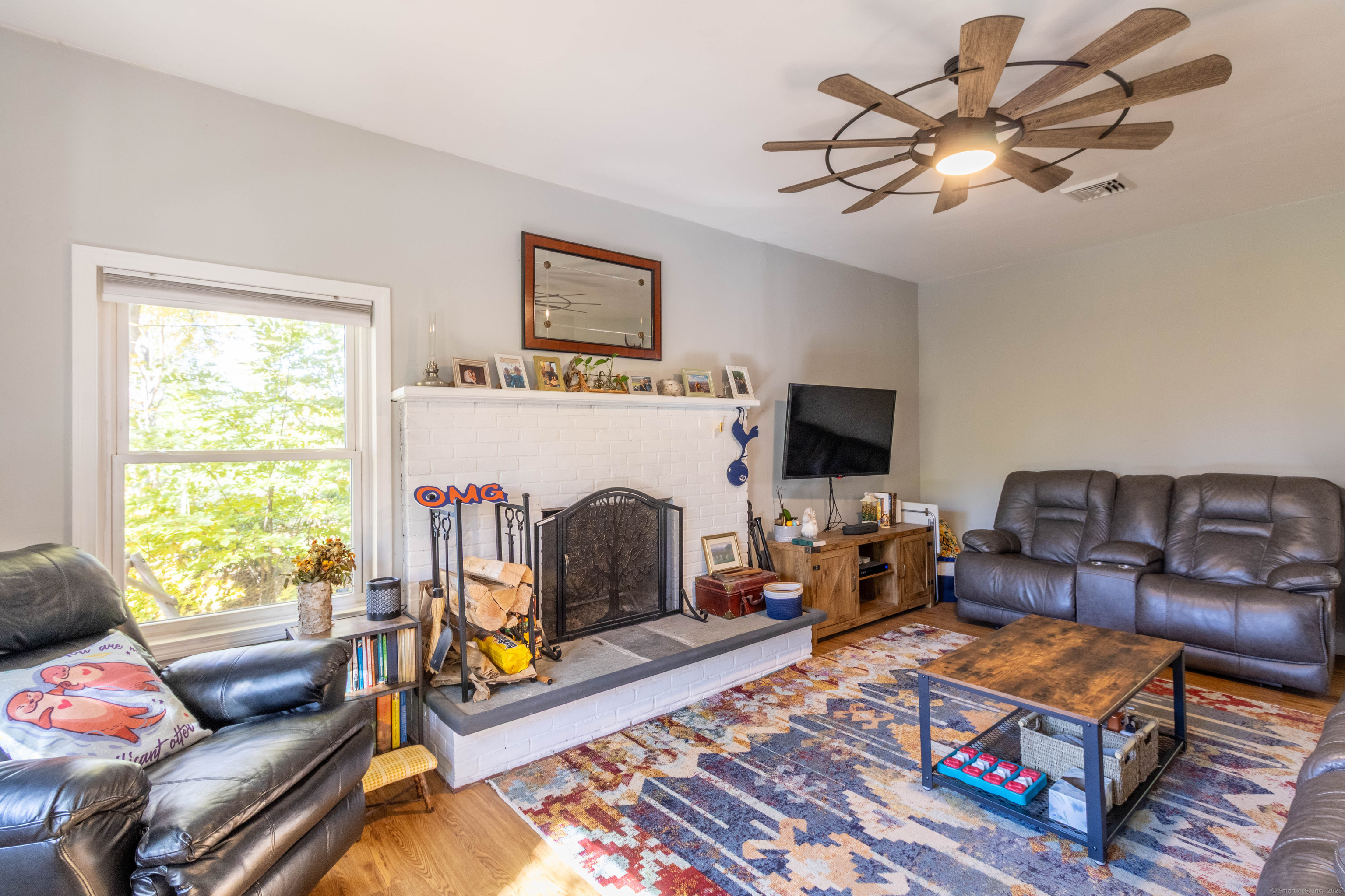 26 Firetown Road Simsbury, CT 06070 - Photo 2 of 40 a living room with furniture a flat screen tv and a fireplace