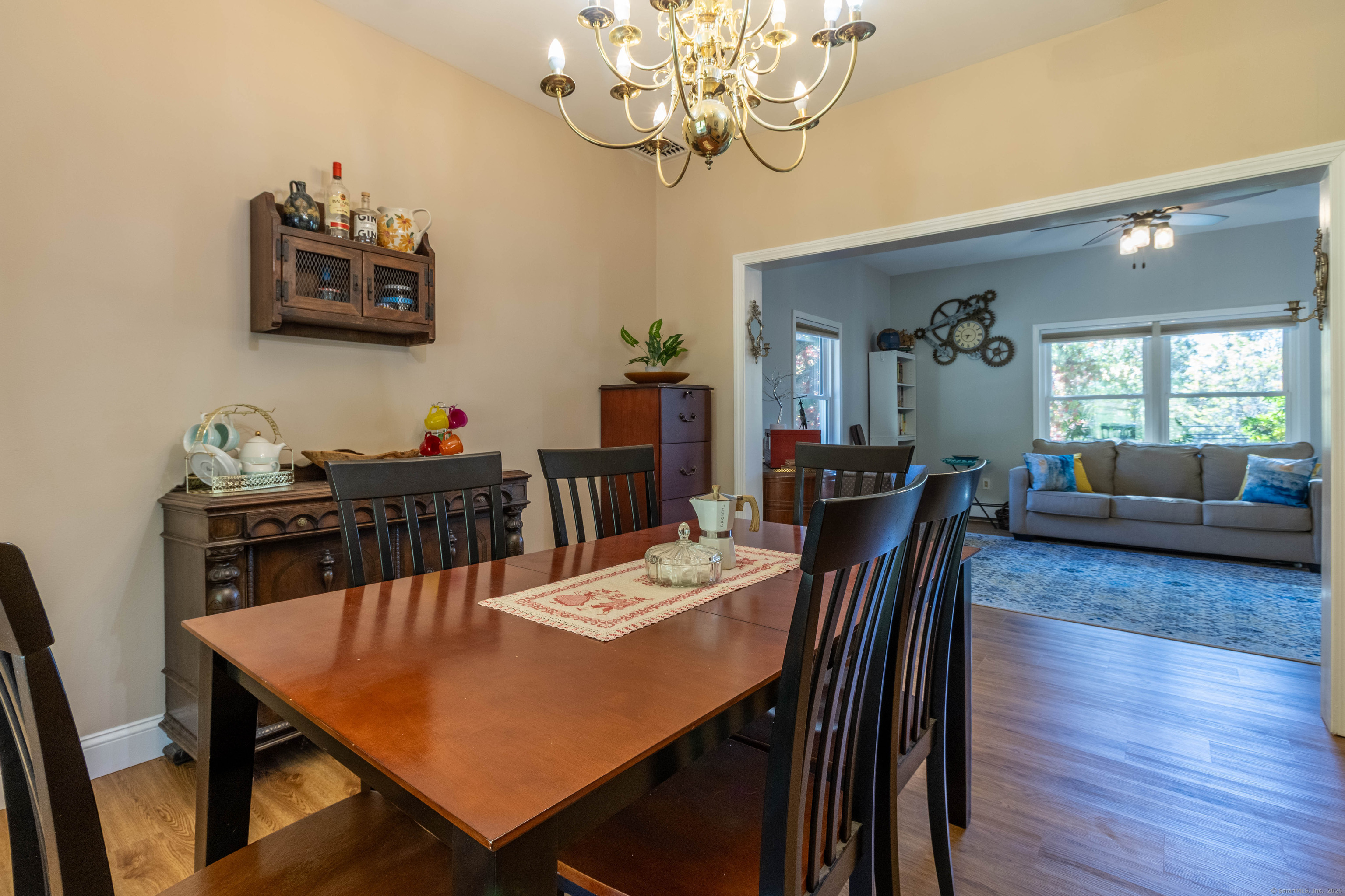 26 Firetown Road Simsbury, CT 06070 - Photo 21 of 40 a view of a dining room with furniture a chandelier and wooden floor