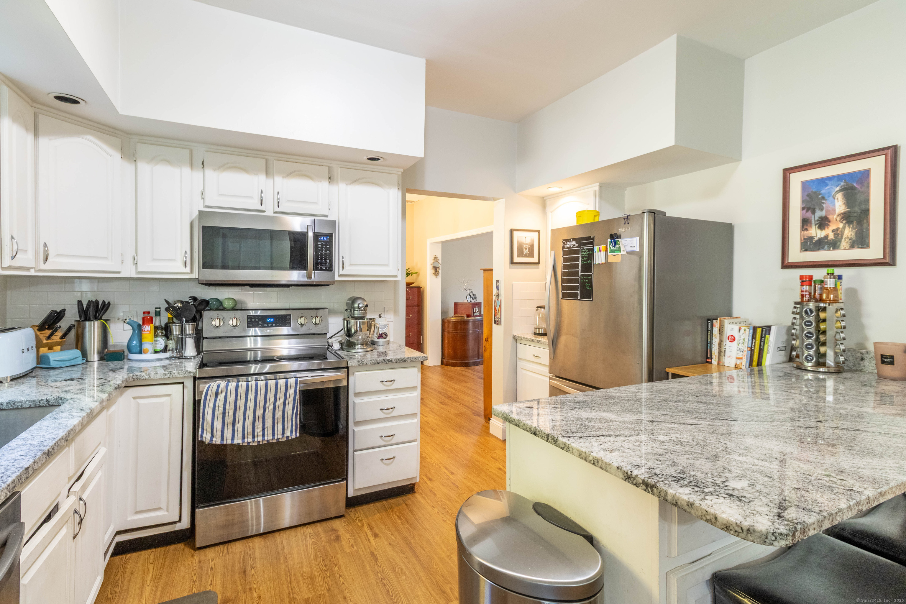 26 Firetown Road Simsbury, CT 06070 - Photo 23 of 40 a kitchen with stainless steel appliances granite countertop a stove top oven a sink and dishwasher
