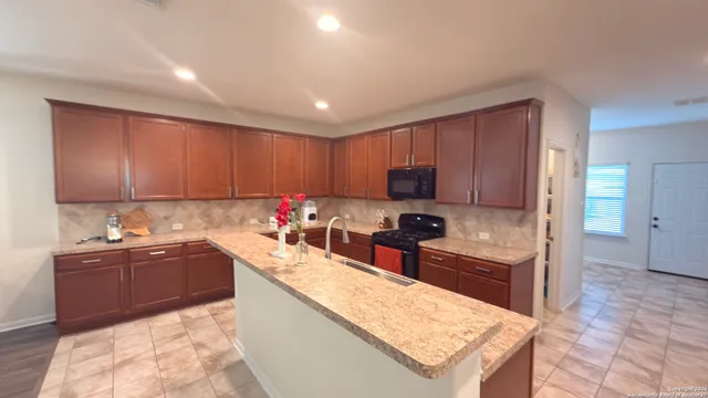a kitchen with a sink a stove and a refrigerator