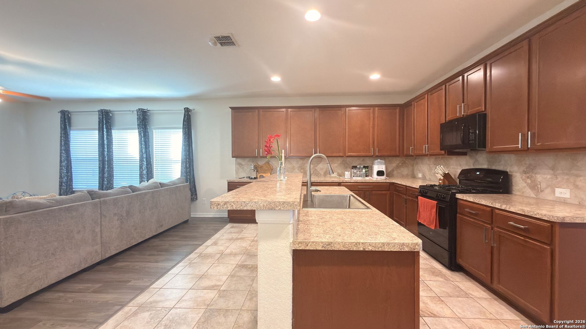8949 Elizabeth Park Converse, TX 78109 - Photo 12 of 35 a large kitchen with kitchen island a sink a counter top space and appliances