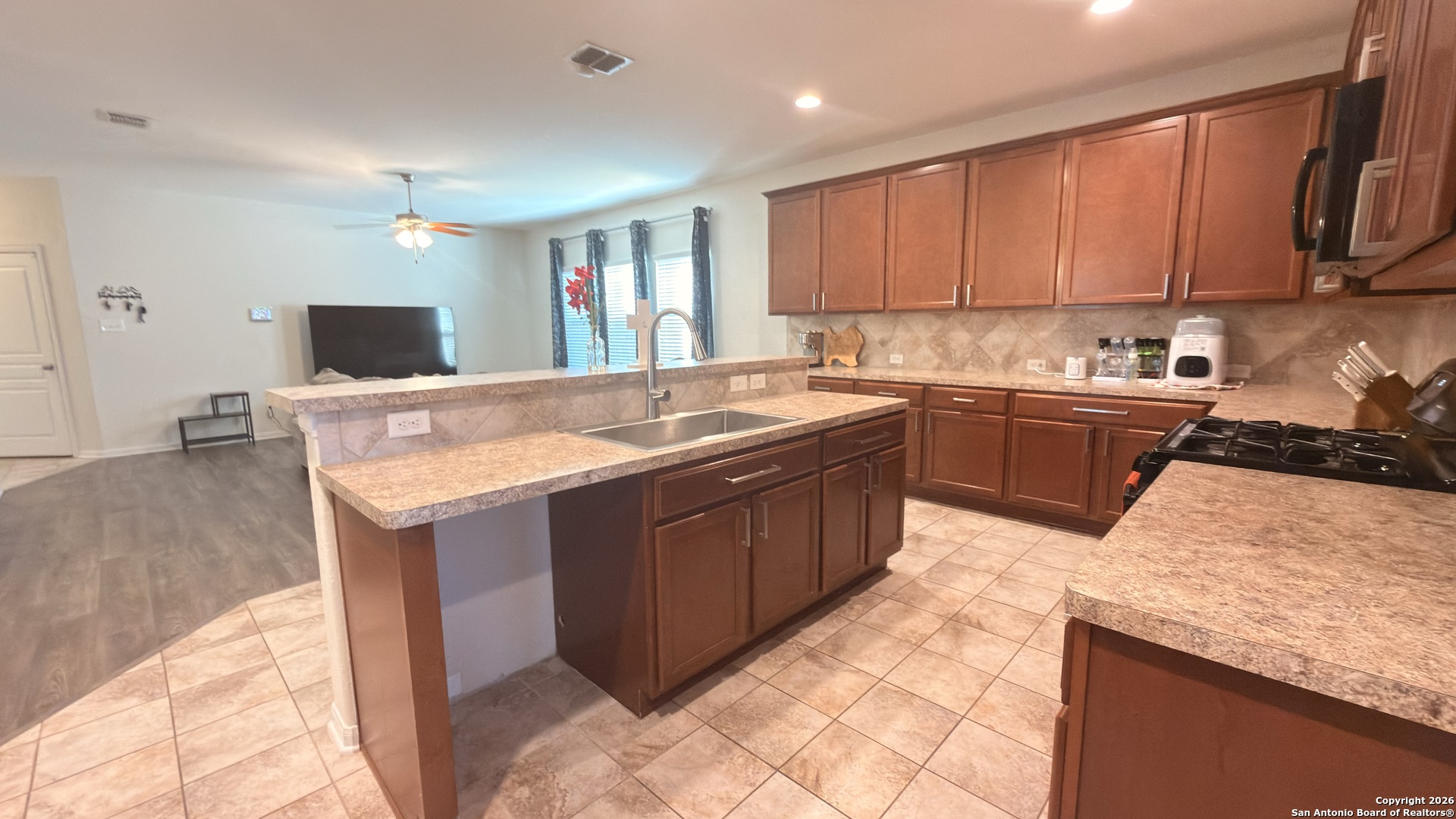 8949 Elizabeth Park Converse, TX 78109 - Photo 13 of 35 a kitchen with stainless steel appliances granite countertop wooden cabinets a sink and dishwasher