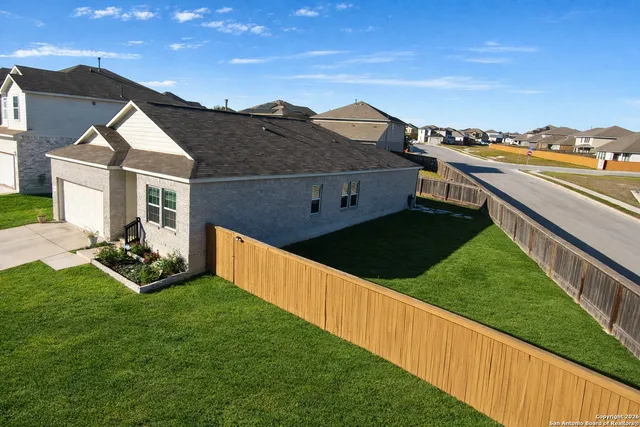 a view of a house with a yard and sitting area